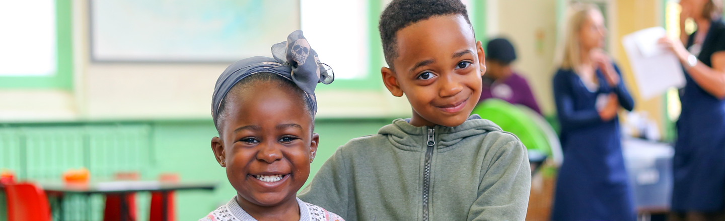 Banner image: Two children smiling at the camera